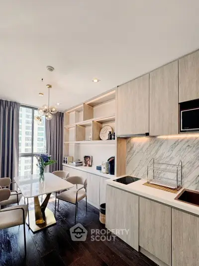 Modern kitchen with sleek cabinetry, marble backsplash, and elegant dining area in a high-rise apartment.