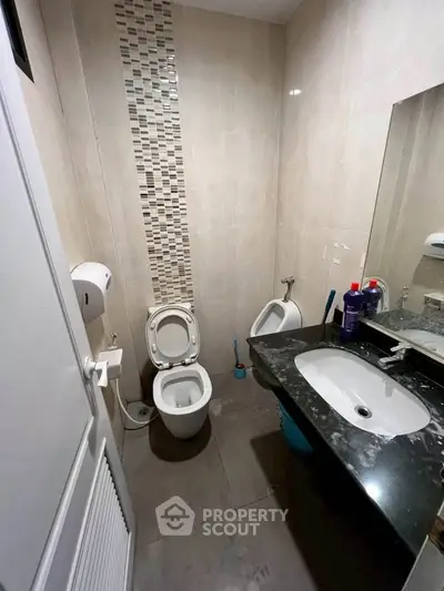Compact bathroom with modern fixtures and stylish tile accents