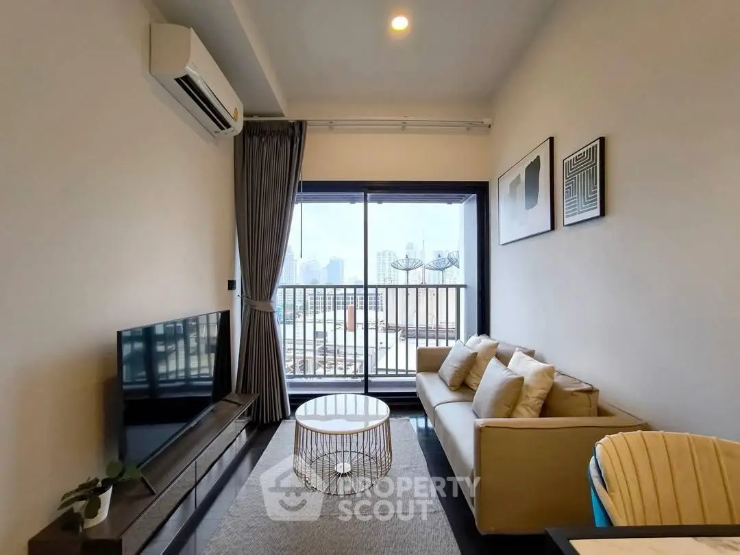 Modern living room with balcony view, stylish furniture, and natural light.