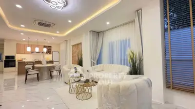 Luxurious open-concept living room with elegant decor and modern kitchen.