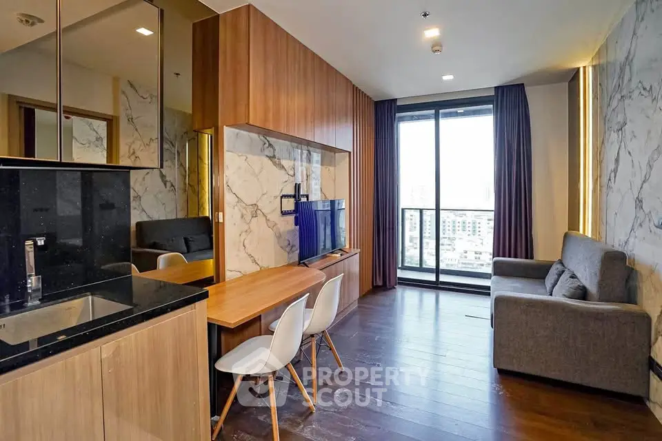 Modern living room with stylish decor and city view balcony in luxury apartment.