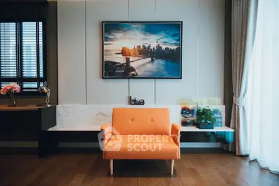 Stylish living room with orange sofa and cityscape artwork, modern interior design.