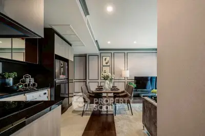 Modern open-plan living and dining area with sleek kitchen design.