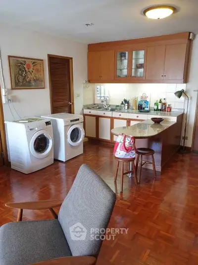 Charming kitchen with wooden cabinets and modern appliances, featuring a cozy seating area and stylish decor.