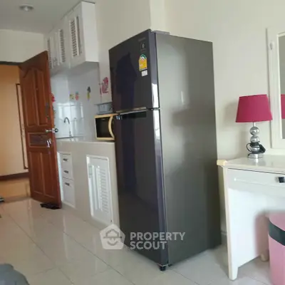 Compact kitchen with modern fridge and stylish decor in cozy apartment