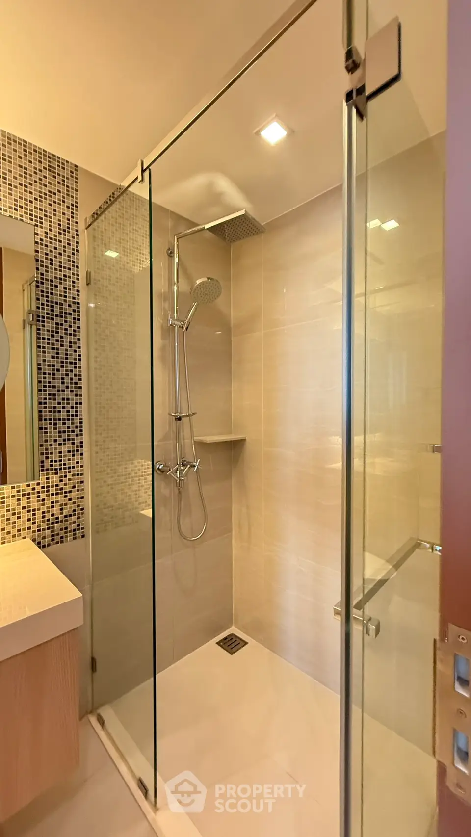Modern bathroom with glass shower enclosure and stylish tile accents