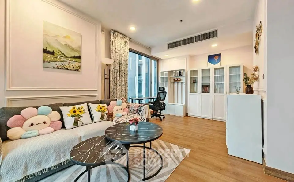 Charming living room with stylish decor and natural light, perfect for relaxation and entertainment.