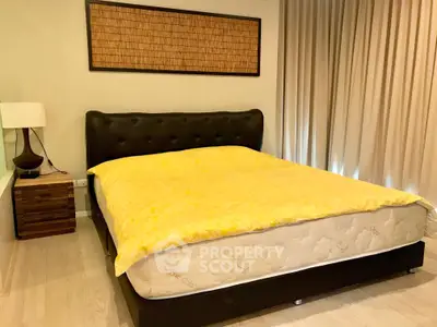Spacious bedroom with elegant decor and cozy ambiance, featuring a plush bed and stylish furnishings.
