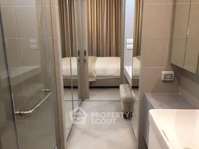 Modern apartment with sleek bathroom and cozy bedroom view