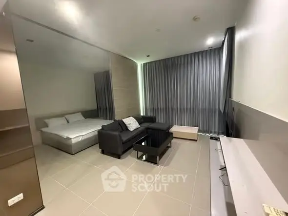 Modern studio apartment with sleek design and cozy living area.