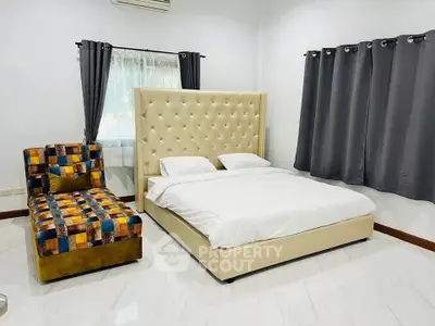Spacious bedroom with modern decor and plush bed in a serene setting.