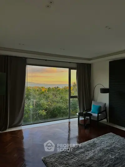 Luxurious living room with stunning sunset view through large windows