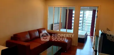 Modern apartment with red leather sofa and city view from bedroom