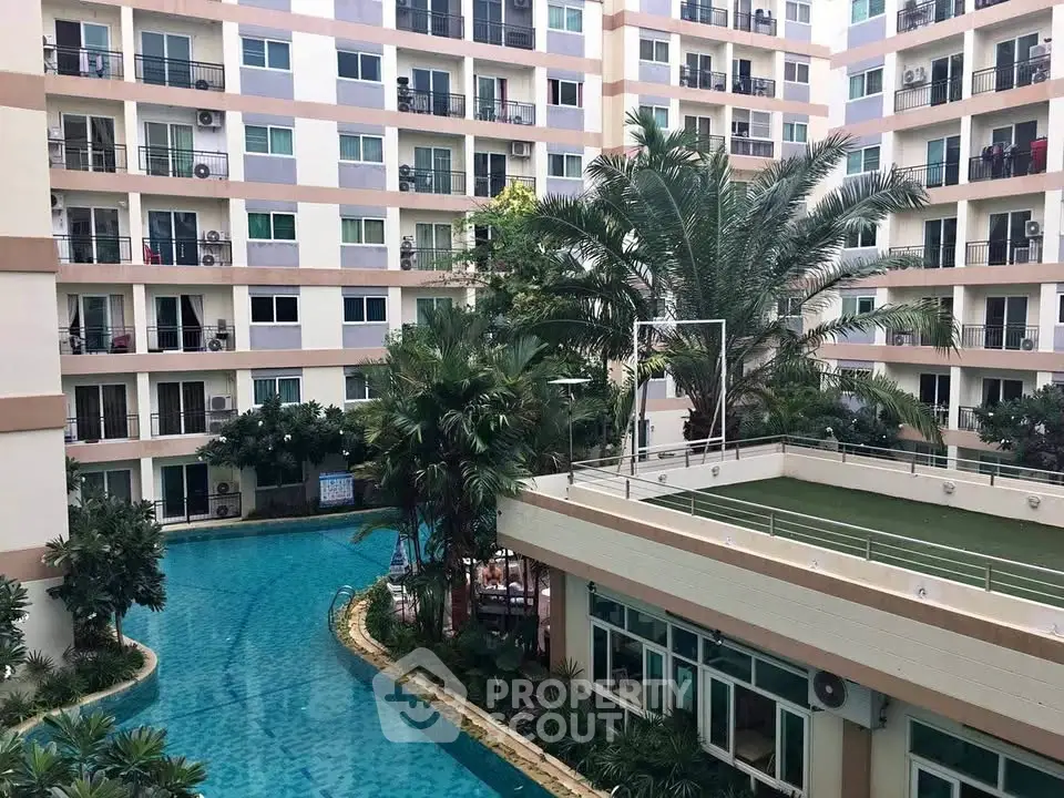 Luxurious apartment complex with pool and lush greenery, perfect for modern living.