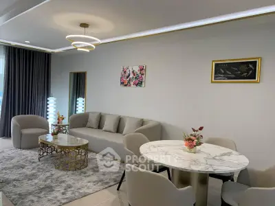 Modern living room with elegant decor, featuring a plush sofa, stylish dining area, and contemporary lighting.