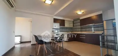 Modern open kitchen with sleek design and dining area in spacious apartment