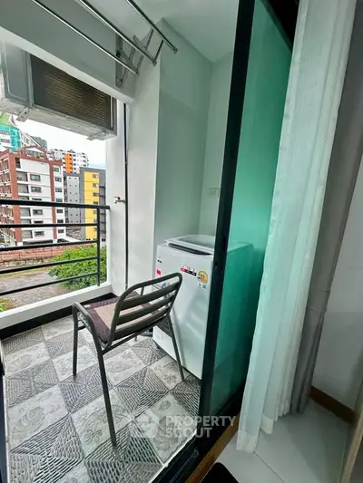 Charming balcony with washing machine and city view, perfect for urban living convenience.