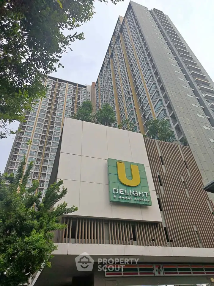 Modern high-rise building with lush greenery and sleek design