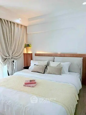 Elegant bedroom with cozy bedding and soft lighting, perfect for relaxation.