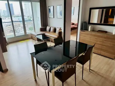Modern open-plan living and dining area with city view balcony.