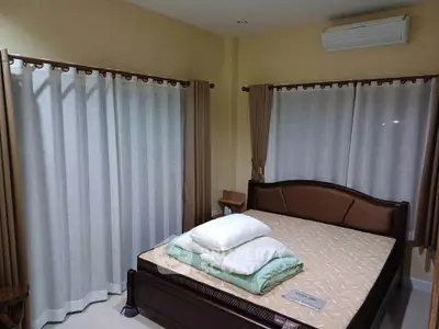 Cozy bedroom with elegant bed and air conditioning, perfect for restful nights.