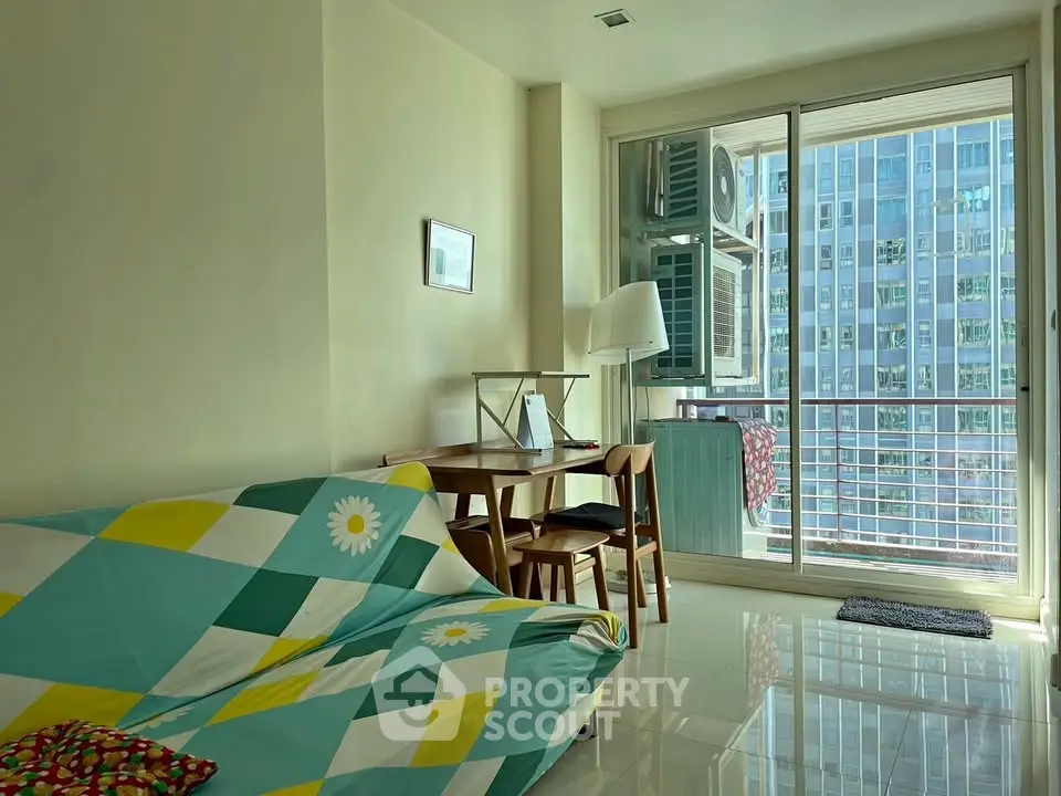Bright living room with modern decor and balcony view in urban apartment
