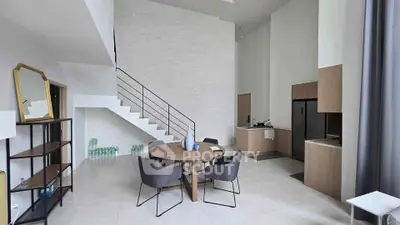 Modern open-plan living room with high ceiling and stylish furniture