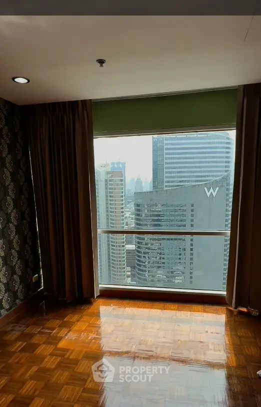 Spacious room with stunning city view and elegant parquet flooring
