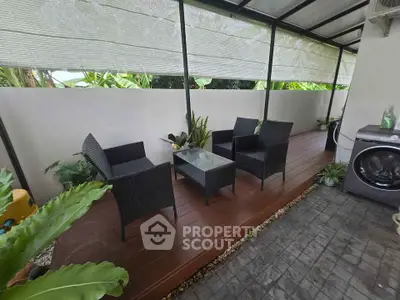 Charming outdoor patio with modern furniture and lush greenery, perfect for relaxation and entertaining.