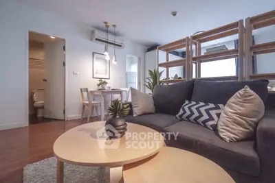 Modern living room with stylish decor and open layout, featuring cozy seating and natural light.