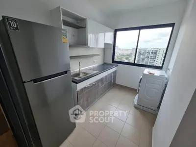 Modern kitchen with sleek appliances and city view from window