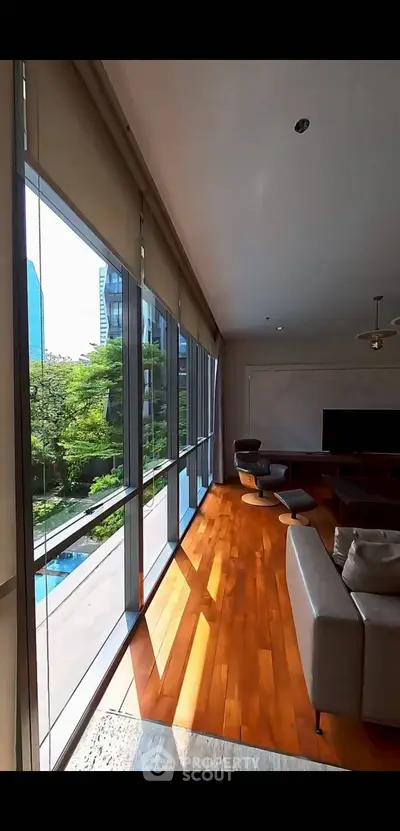 Luxurious living room with floor-to-ceiling windows and stunning city view