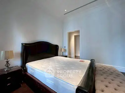 Spacious bedroom with elegant bed and stylish decor in a luxury home.