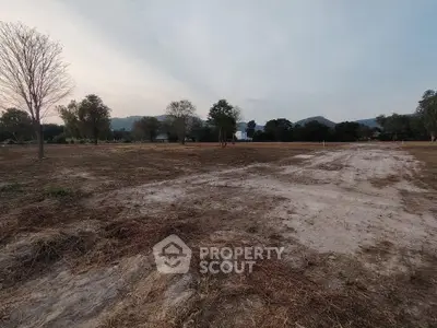 Expansive vacant land with scenic mountain backdrop, ideal for development or investment opportunities.