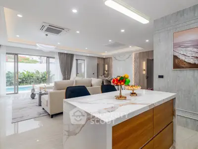Luxurious open-plan living room with modern kitchen island and elegant decor