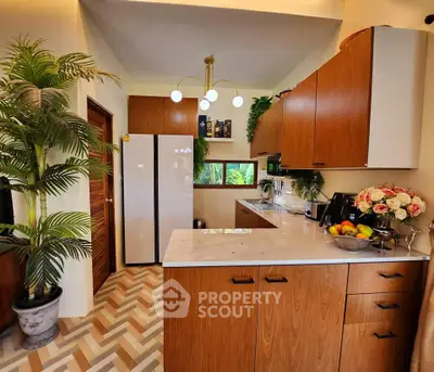 Modern kitchen with wooden cabinets and stylish lighting