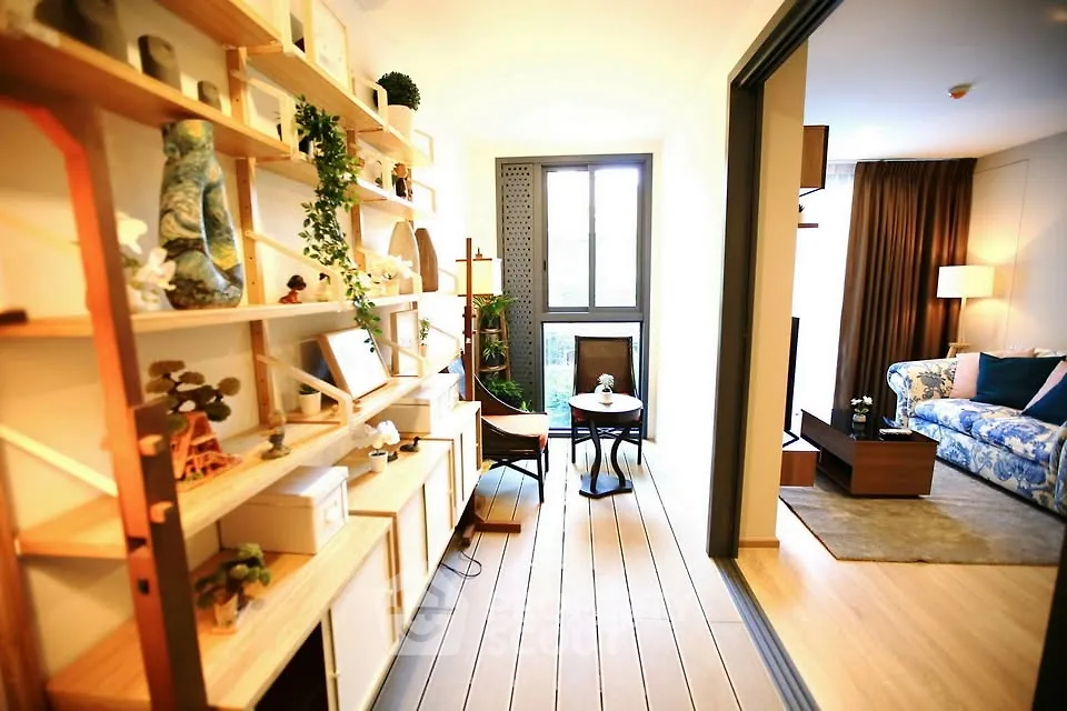 Stylish living room with open layout and elegant decor, featuring a cozy seating area and modern shelving.