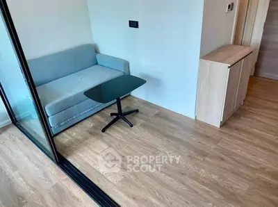 Modern living room with sleek glass partition and cozy sofa