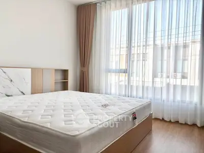 Bright bedroom with large window and modern decor