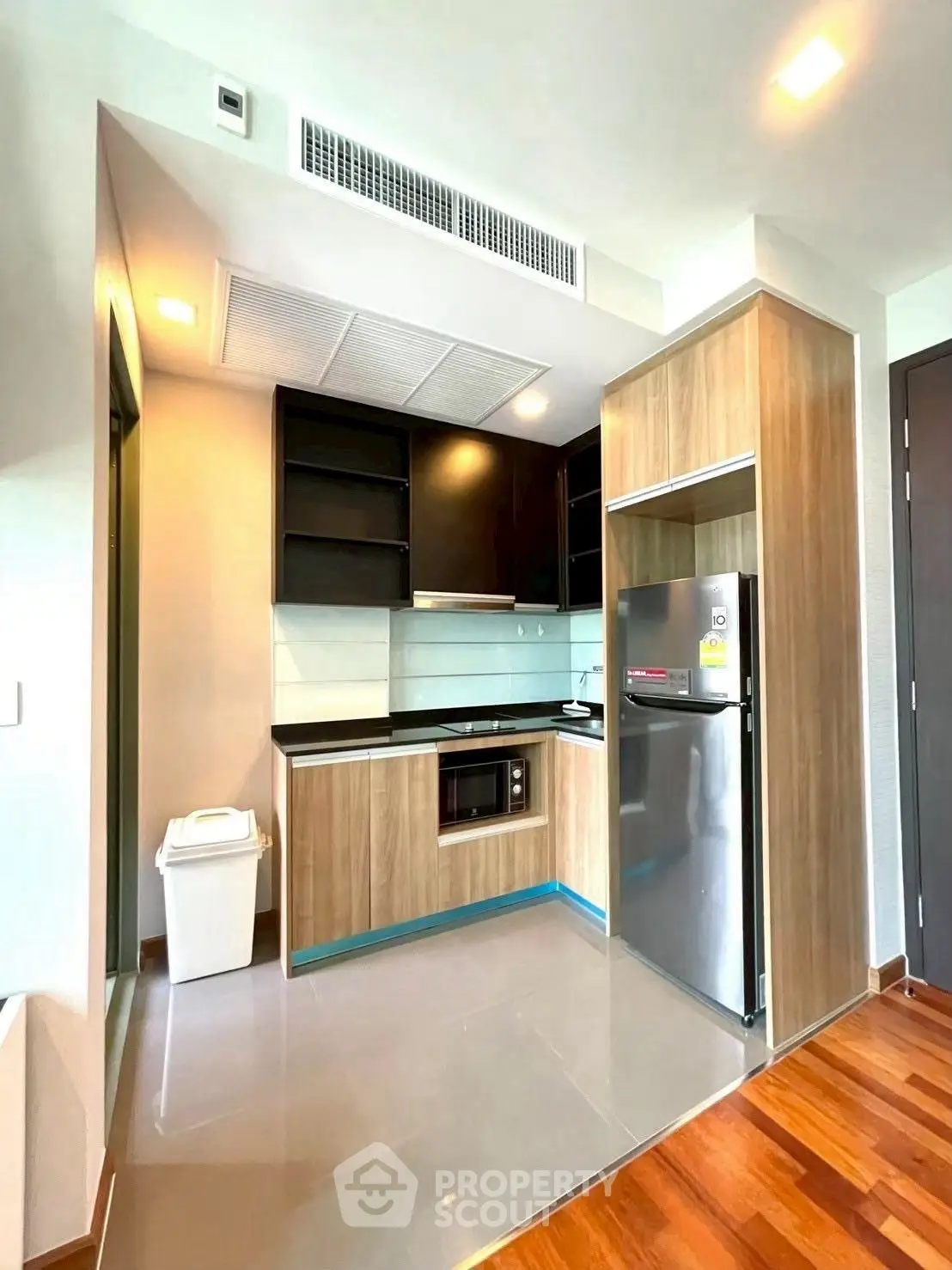 Modern kitchen with sleek cabinetry and stainless steel appliances in a compact layout.