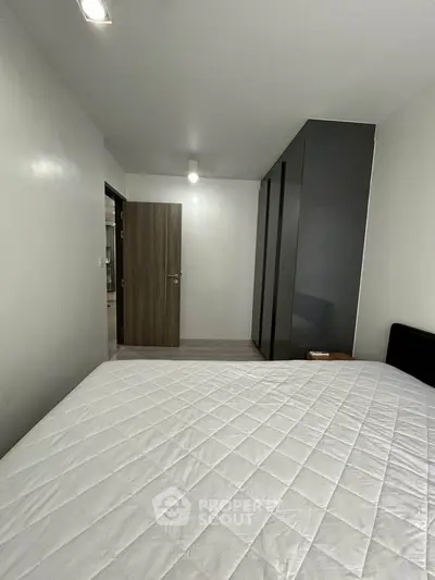 Modern bedroom with sleek wardrobe and minimalist design