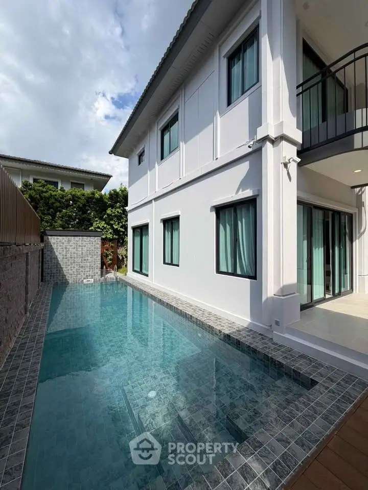 Modern two-story house with private swimming pool and elegant exterior design.