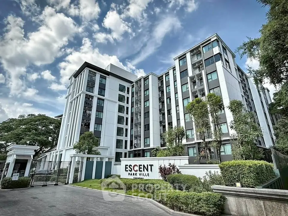 Modern residential building with lush landscaping and clear blue sky