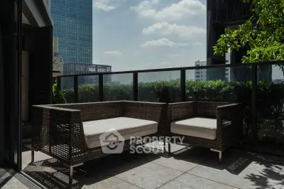 Spacious balcony with modern seating and city view, perfect for relaxation and entertaining.