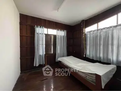 Cozy wooden bedroom with natural light and simple furnishings
