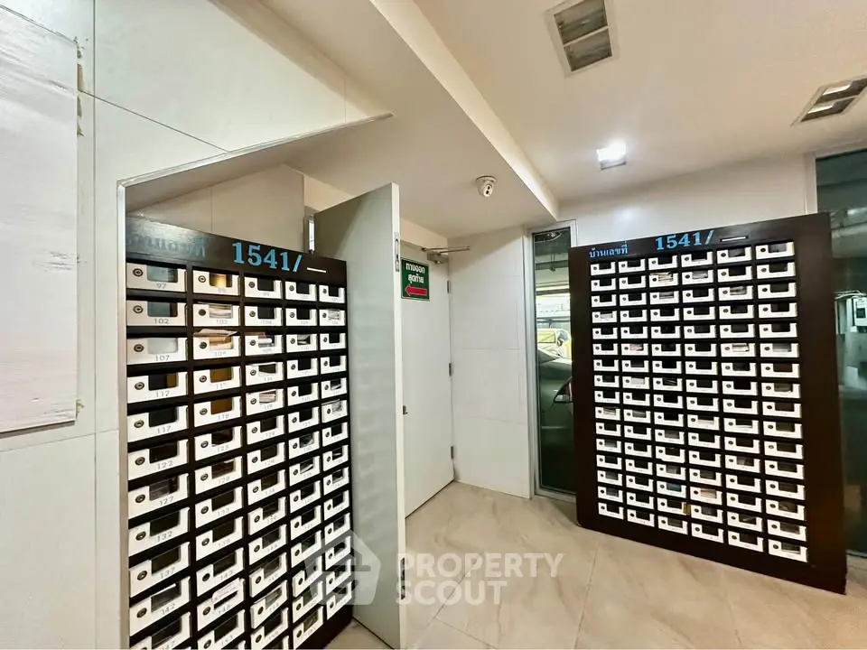 Modern apartment building mailroom with organized mailboxes and secure access.