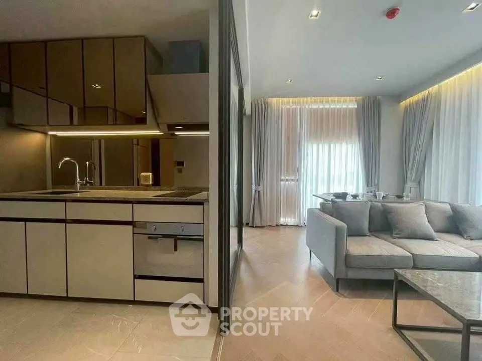 Modern open-plan kitchen and living room with sleek design and natural light