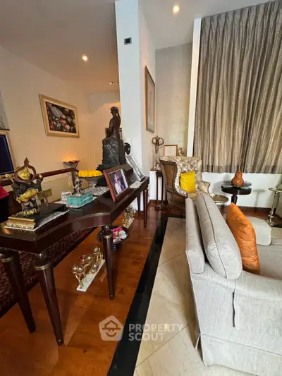 Elegant living room with luxurious decor and stylish furniture, featuring a cozy seating area and decorative accents.