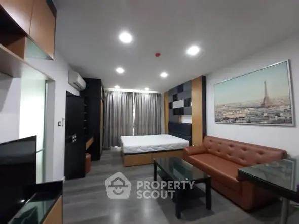 Modern studio apartment with stylish decor and cityscape artwork