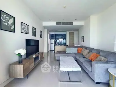 Spacious modern living room with stylish decor and open kitchen layout.